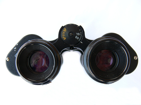 An old military binoculars used in wars isolated.