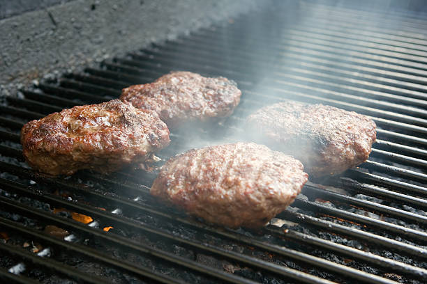 istock Hamburgers smoking on grill 140263267