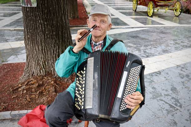 istock Old man playing flute and accordion 1402635835