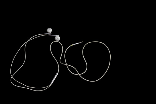 White Minimalist Wired Earphone at Black Background, for Music or Audio Design Element