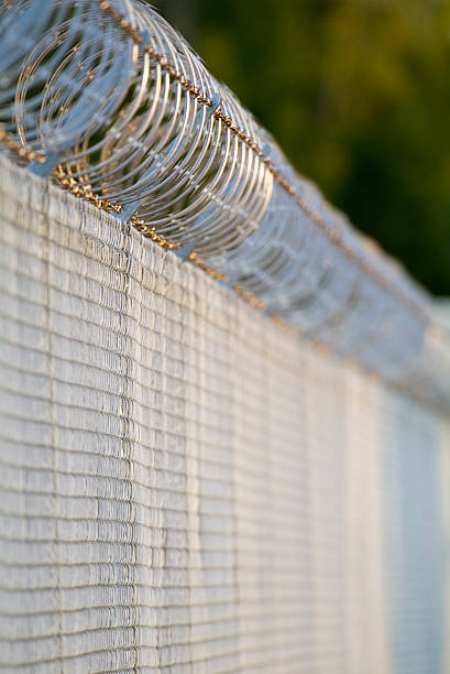 istock security razor and barbed wire fence short DOF 140263680