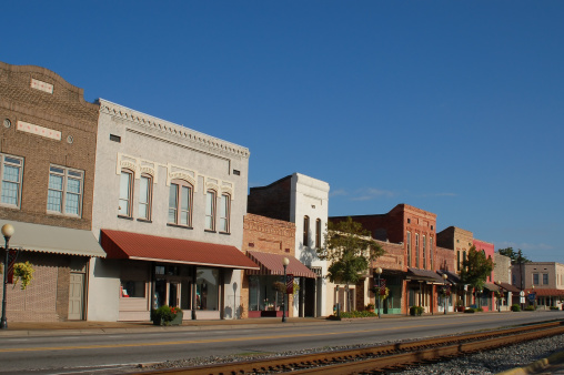 Colorful old restored buildings in downtown Brewton, Alabama. Facing the railroad tracks.