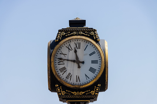 Old retro vintage street clock sky background