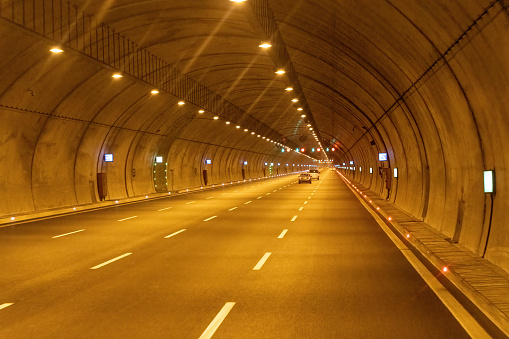 Highway vehicle tunnel inside. Multi-lane road tunnel