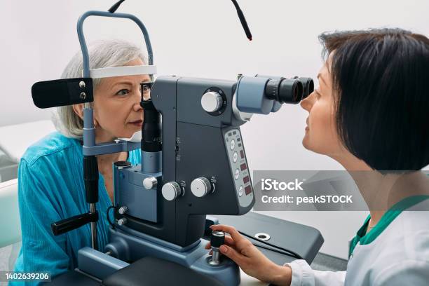 Female Optometrist Doing Sight Test To Senior Woman At Modern Ophthalmology Clinic Eye Exam And Vision Diagnostic Stock Photo - Download Image Now