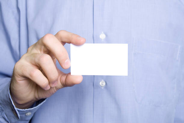 Business young man in a blue shirt holding a blank business card