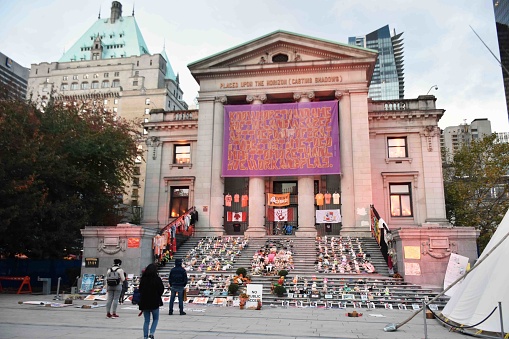 Scene Of Vancouver Art Gallery In British Columbia Canada, People, Children's Boots And Shoes On The Ground As A Memorial For All The Dead first Nations Children