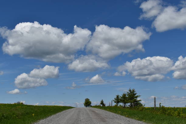 Un ciel bleu A country road in spring, Quebec, Canada ciel bleu stock pictures, royalty-free photos & images