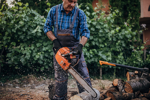 Cutting wood with a chainsaw
