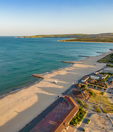 Sellin pier of the island of Rügen on the Baltic Sea in the golden evening sun with beach chairs in the foreground