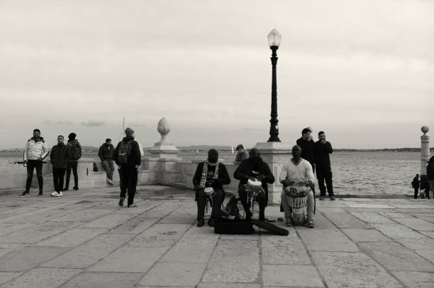 Lisbon, Portugal - Mars 13, 2022: Street musicians play percussion by the Tagus River in Lisbon downtown.