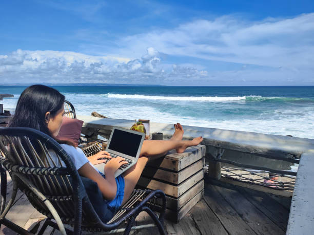 Young Indonesian Woman Working With a Beach View