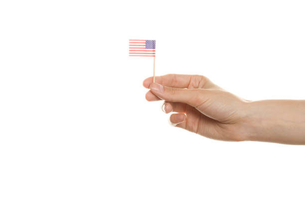 Close up of woman hand. In his hand the American flag. Isolation
