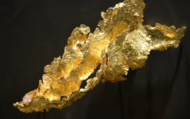 Unusual and stunning rare gold flakes in a freeform catching the light.