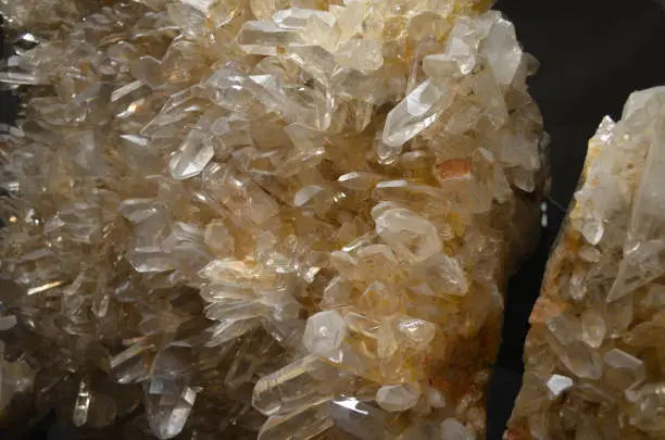 Group of semi precious quartz crystals growing together in a  large cluster.