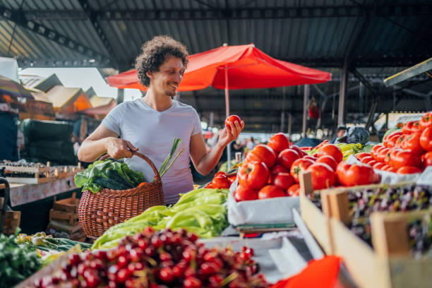 istock Man buying fresh vegetables at market 1402647954