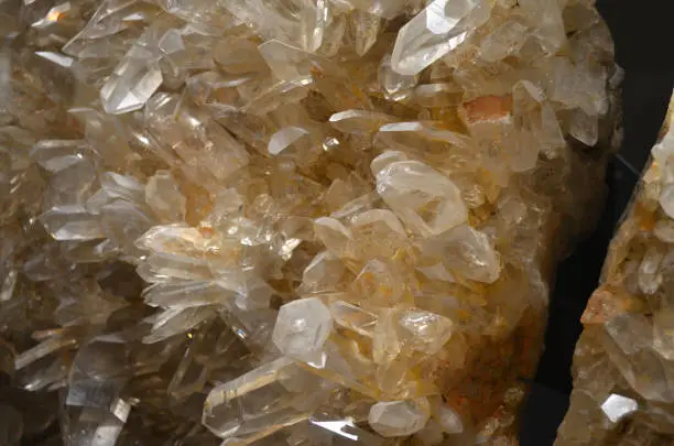 Group of crystal quartz geodes and prisms growing together in a cluster.