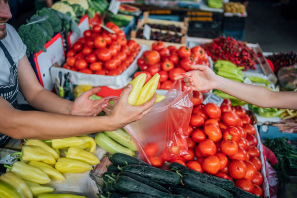istock Customer buying fresh vegetables at market 1402648145