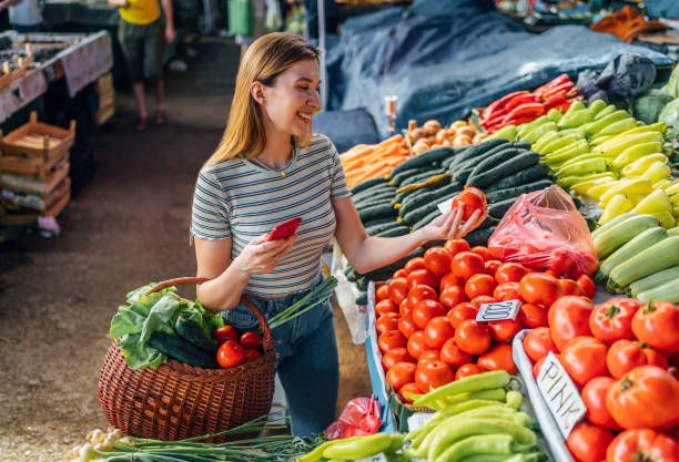 istock Woman choosing tomatoes 1402648532