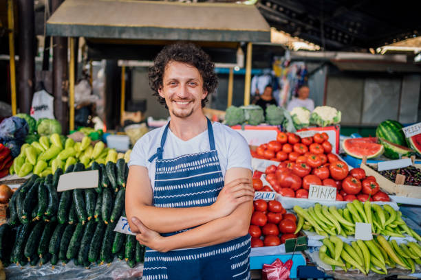 istock Smiling young market vendor 1402649081