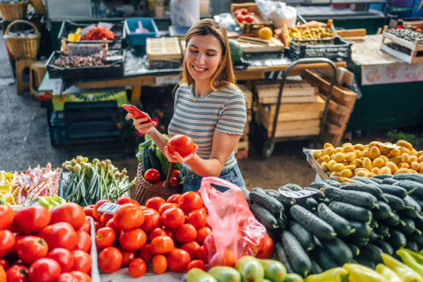 istock Woman choosing tomatoes 1402650309