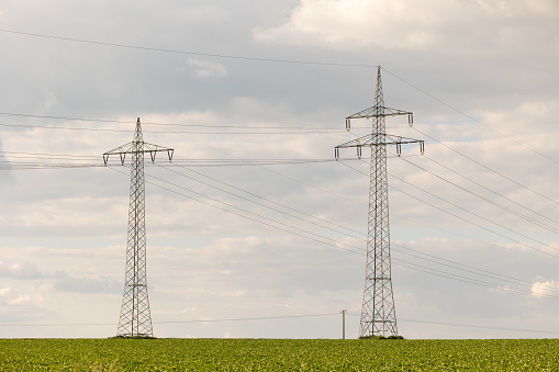 Rodheim, Wetterau, Hesse, Germany, June 2020: Landscape with power poles and a lot of clouds.