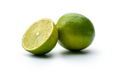 Ripe lime with a half on white background