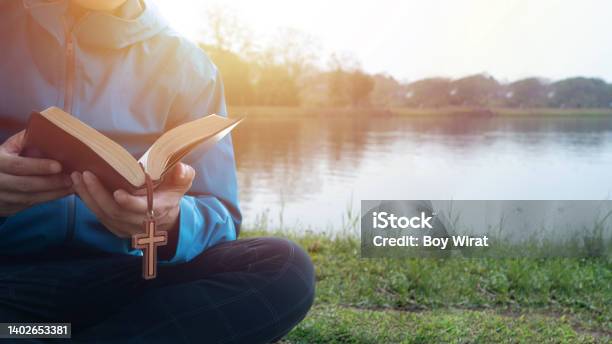 Man Reading Bible By Lake In The Morning Stock Photo - Download Image Now - Praying, Christianity, Spirituality