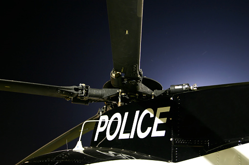 Part of the rotors and top of a police helicopter