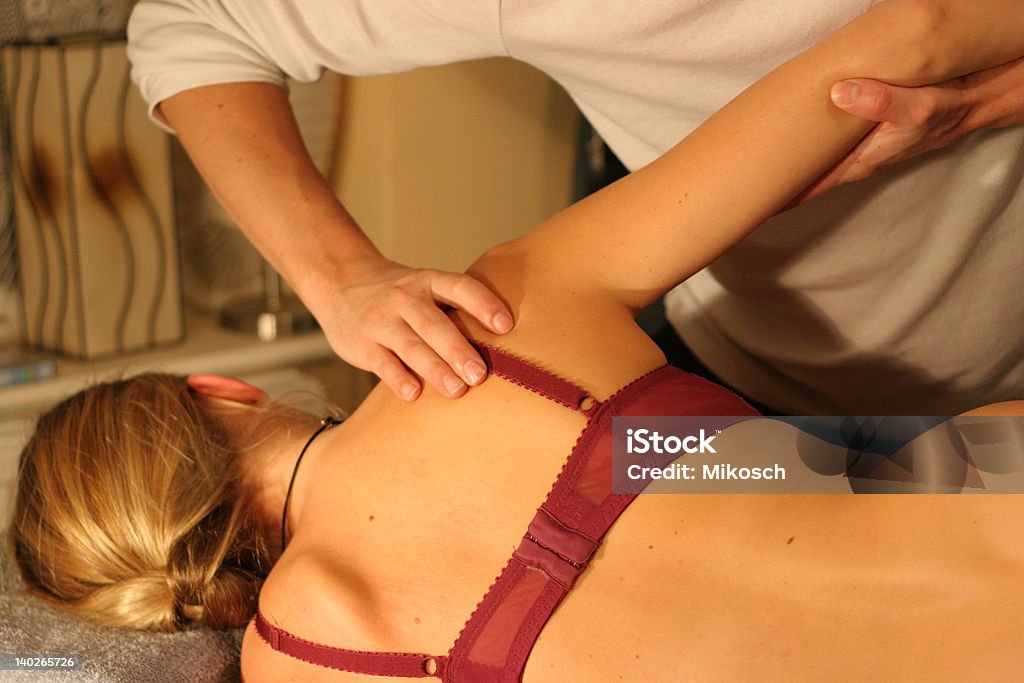 Osteopathy An osteopath treating a female patient Back Stock Photo
