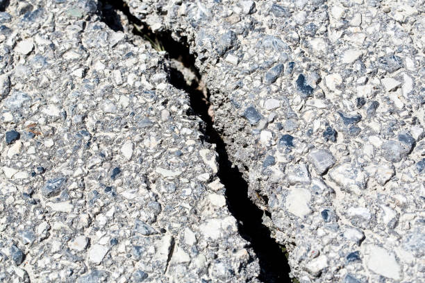Cracked, broken and damaged asphalt road detail