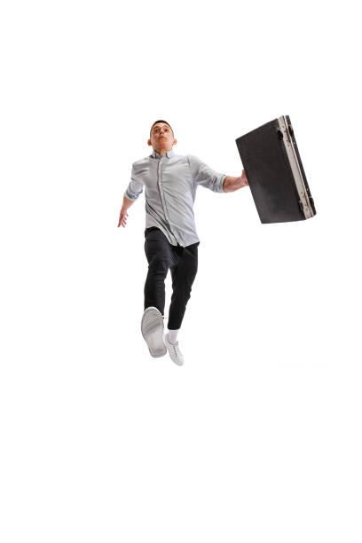 istock Portrait of young man. office worker with suitcase, walking isolated over white studio background. 1402658559