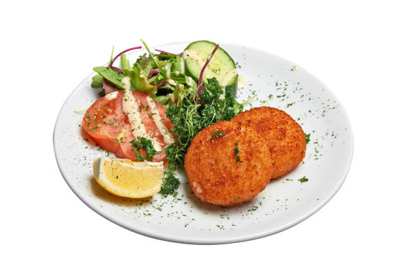 istock White plate with two Cheese croquettes ans salad Isolated 1402658886