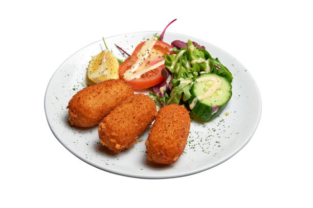 istock White plate with three Shrimps croquettes ans salad Isolated 1402658889