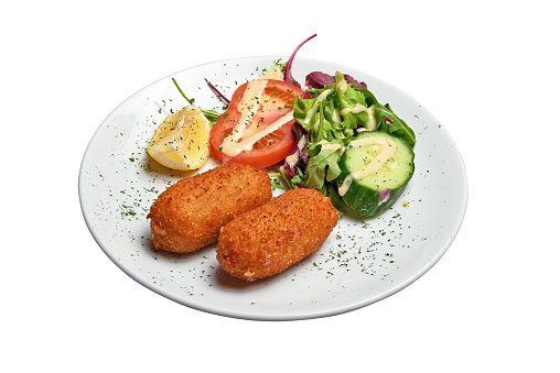 White plate with two Shrimps croquettes ans salad. Isolated with clipping path