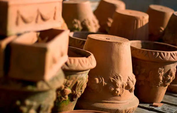 Pile of terracotta pots, ona wooden bench, with some mold. Please see portfolio for more.