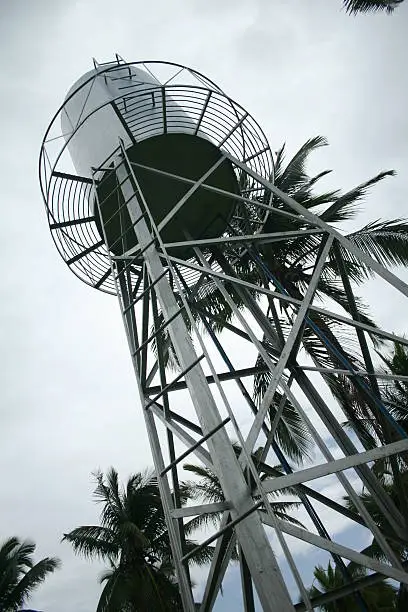 a water tank at the middle of a coconut plantation supplying the workers' water needs.