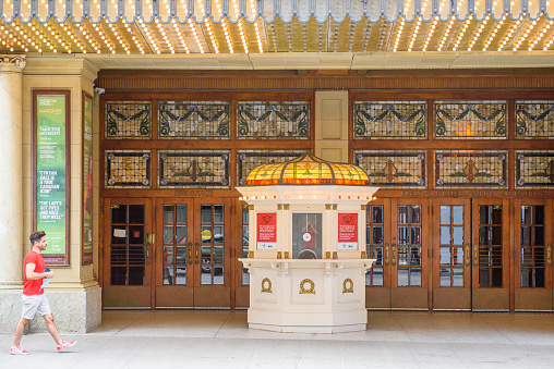 Toronto, Canada - June 26, 2022: A person walks by the facade of the Elgin and Winter Theatres. The building is the only Edwardian architecture stacked theatres in the World.