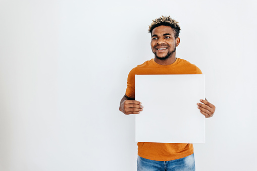 One black man holding white picture frame with empty copy space