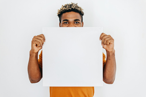 One black man holding white picture frame with empty copy space