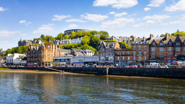 Holidays in Scotland - scenic view of Oban on the west coast of Scotland Holidays in Scotland - the Harbour of Oban and the Mccaig's Tower reflecting in the Water argyll and bute stock pictures, royalty-free photos & images