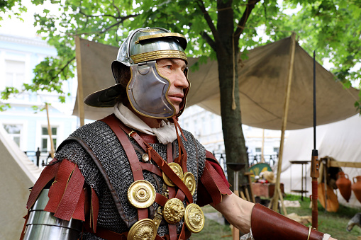 Moscow, Russia - June 2022: Soldier of a Roman Legion during historical festival Times and epochs in Moscow. Legionary in camp, army of Ancient Rome