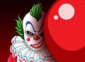 istock Creepy clown face peeking out from behind balloon 1402665124