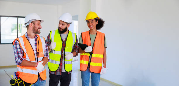istock In doors. Professional Mechanical Engineer team wearing safety hard hat helmet working in  manufacturing factory under construction site. 1402665654