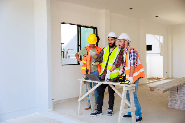 istock In doors. Professional Mechanical Engineer team wearing safety hard hat helmet working in  manufacturing factory under construction site. 1402665656
