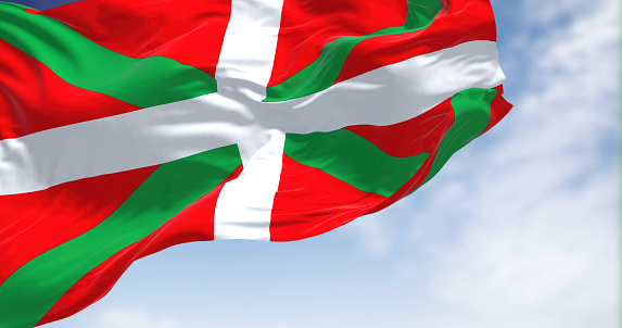 The Basque Country flag waving in the wind on a clear day. The Basque Country is an autonomous community in northern Spain