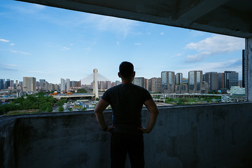 Asian men watching urban scenery