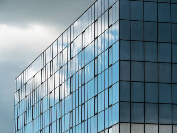 istock Modern Building Glass Facade Reflecting Cloudy Blue Sky 1402670265