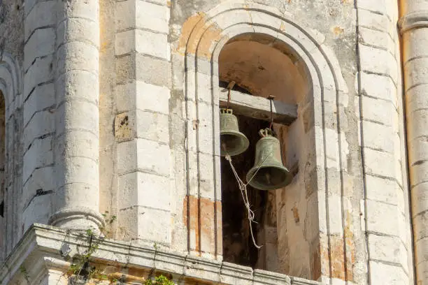 Bells of the old chapel. Greened old bells of the Catholic Church in the colonial style.