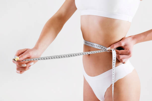 istock Underwear model with tape measure in studio. 1402672518